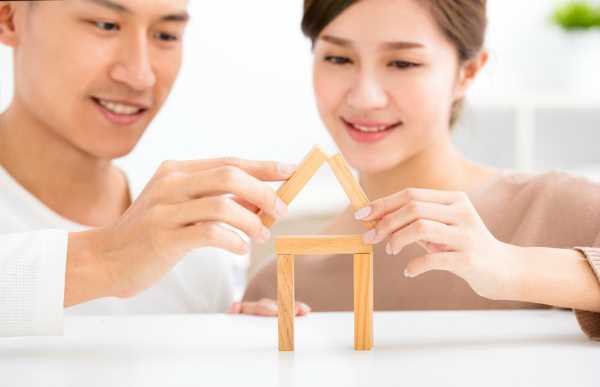 A couple playing with wooden blocks