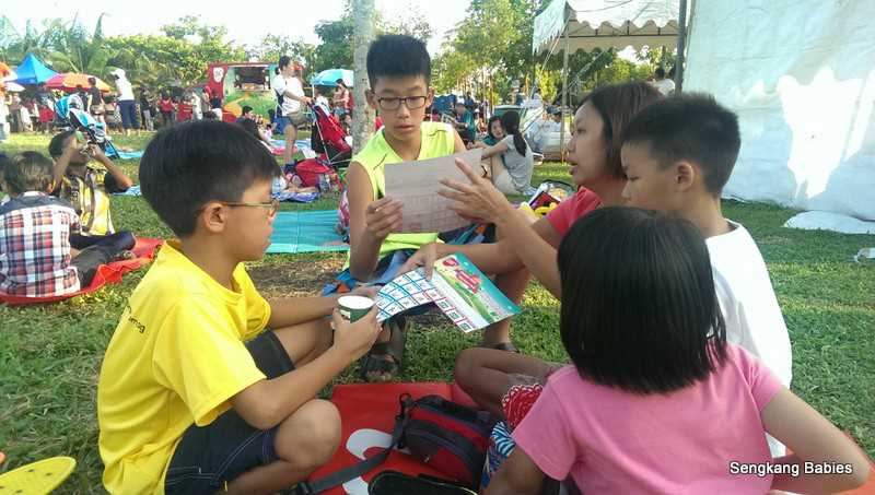 Andy's family looking at the picnic coupons from the goodie bags