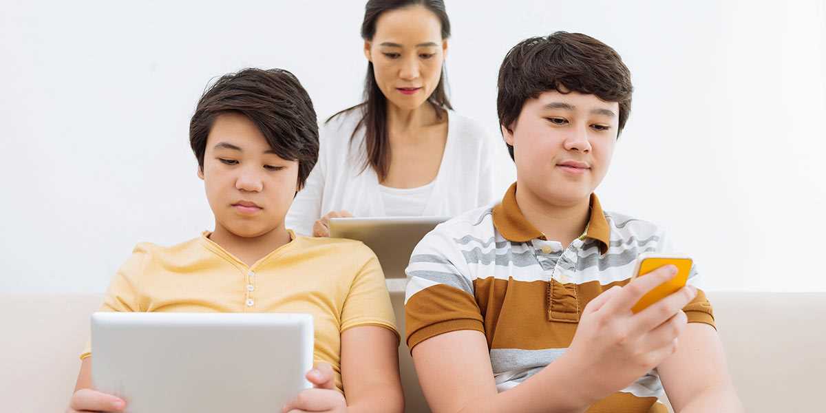 A mother and her two sons using mobile devices